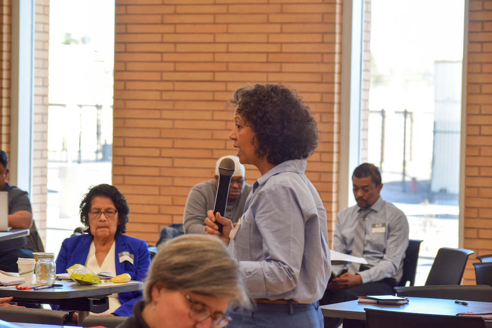 Marisol Bello walking among participants at training in Albuquerque 